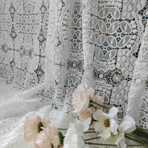 Sheer white lace with delicate decorative patterns